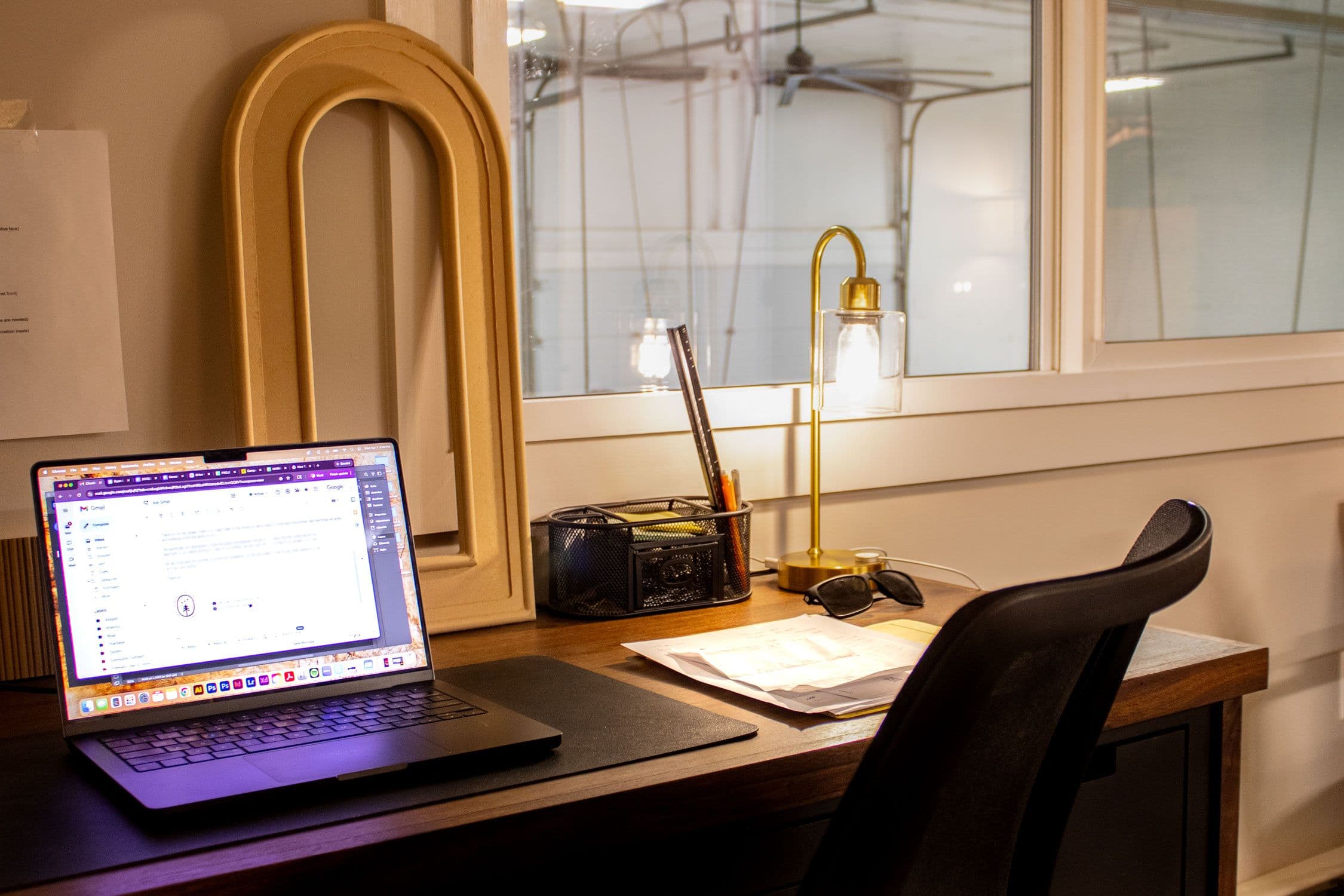 Millwork shop office; open laptop with email pulled up.