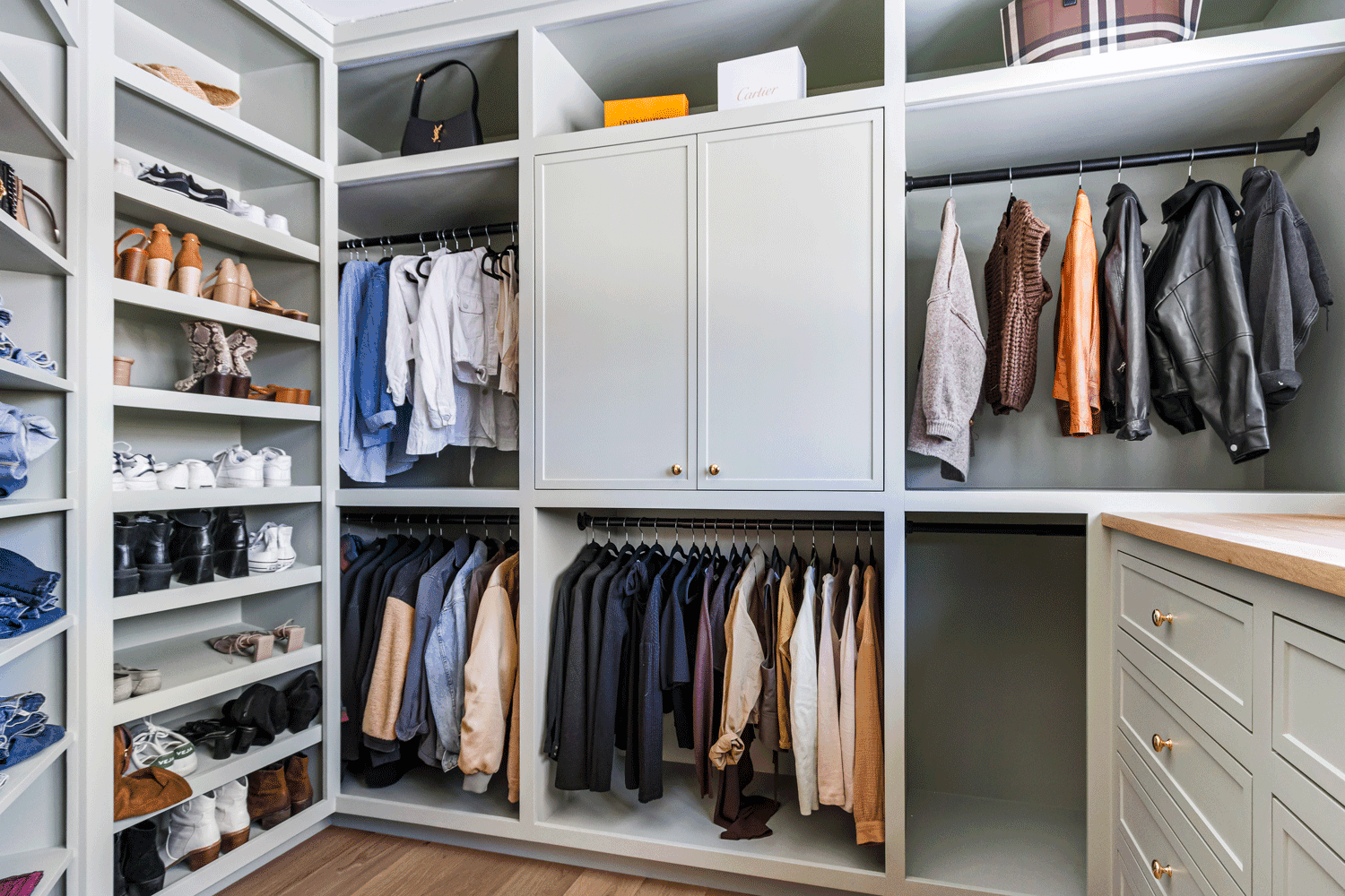 Custom walk-in closet built-in for a new construction home in Cumberland Foreside featuring built-in shelves, drawers and cabinetry