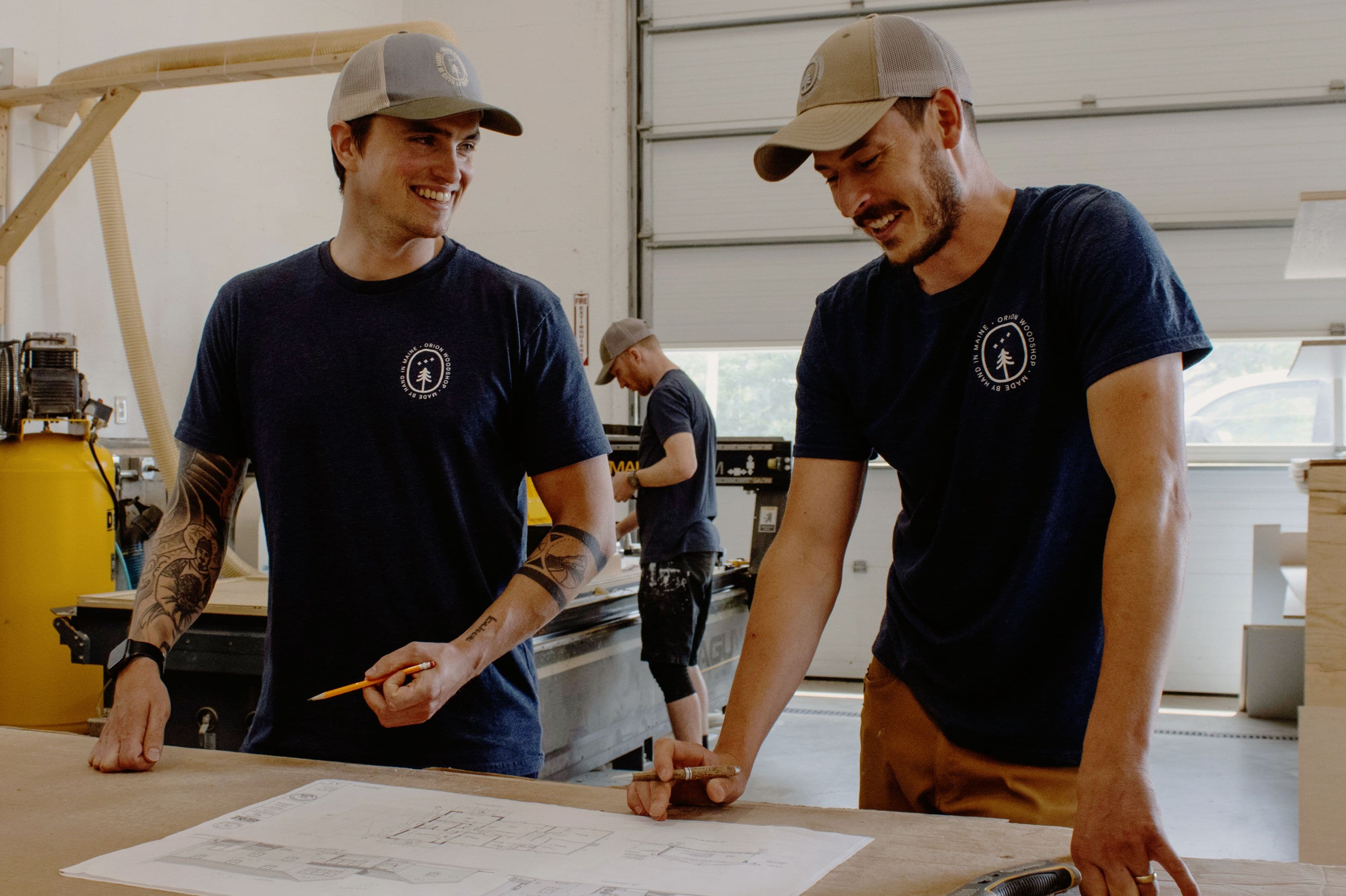 Orion Woodshop co-owners of Ryan Cathcart and Reece Teixeira reviewing architectural plans