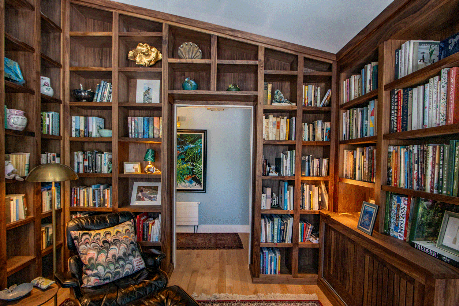 Custom millwork project: floor-to-ceiling home library built-in at a residence in Bath, Maine made from walnut hardwood with natural finish.