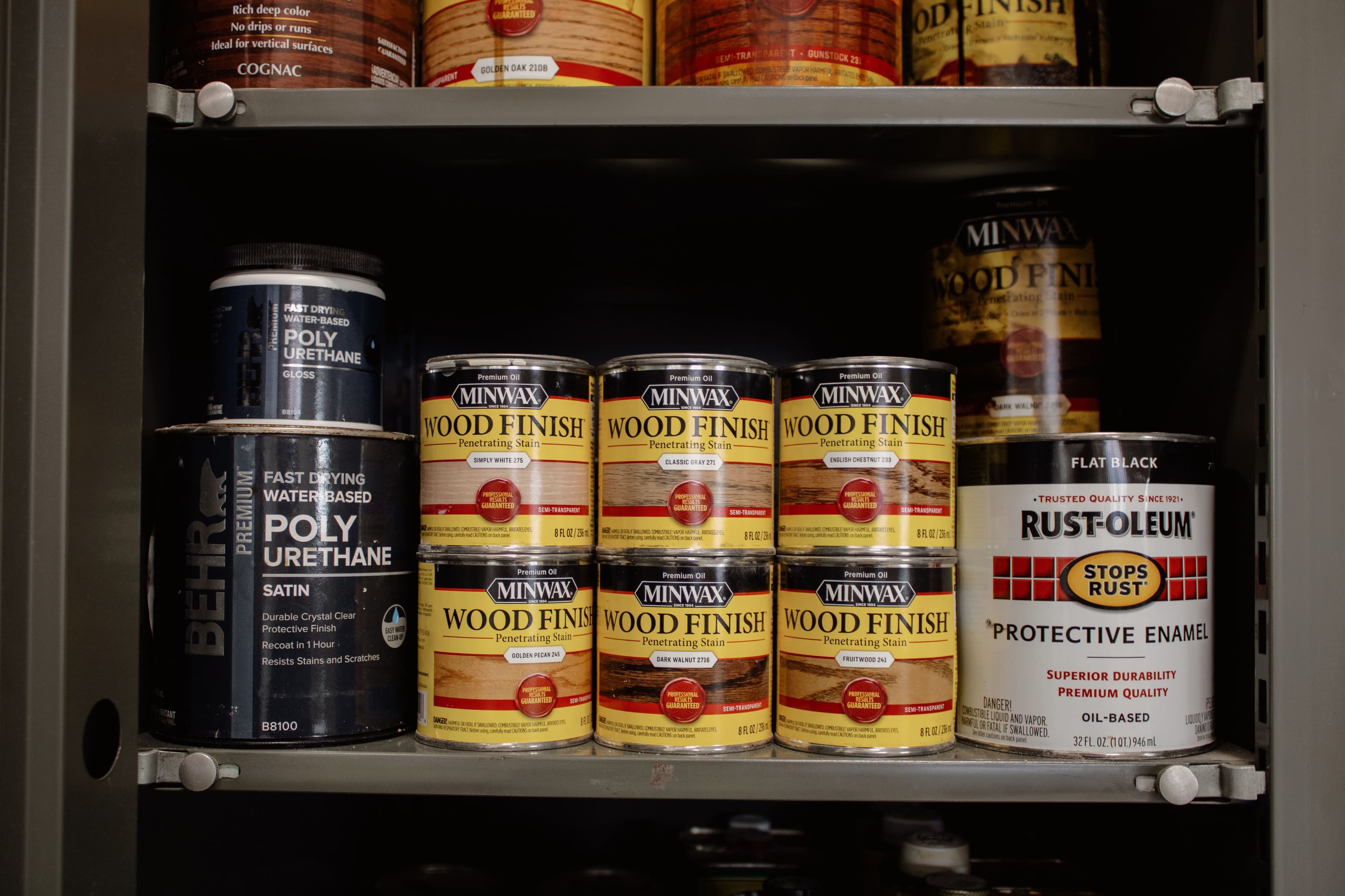 Storage cabinet with assorted finish types and colors inside Orion Woodshop.