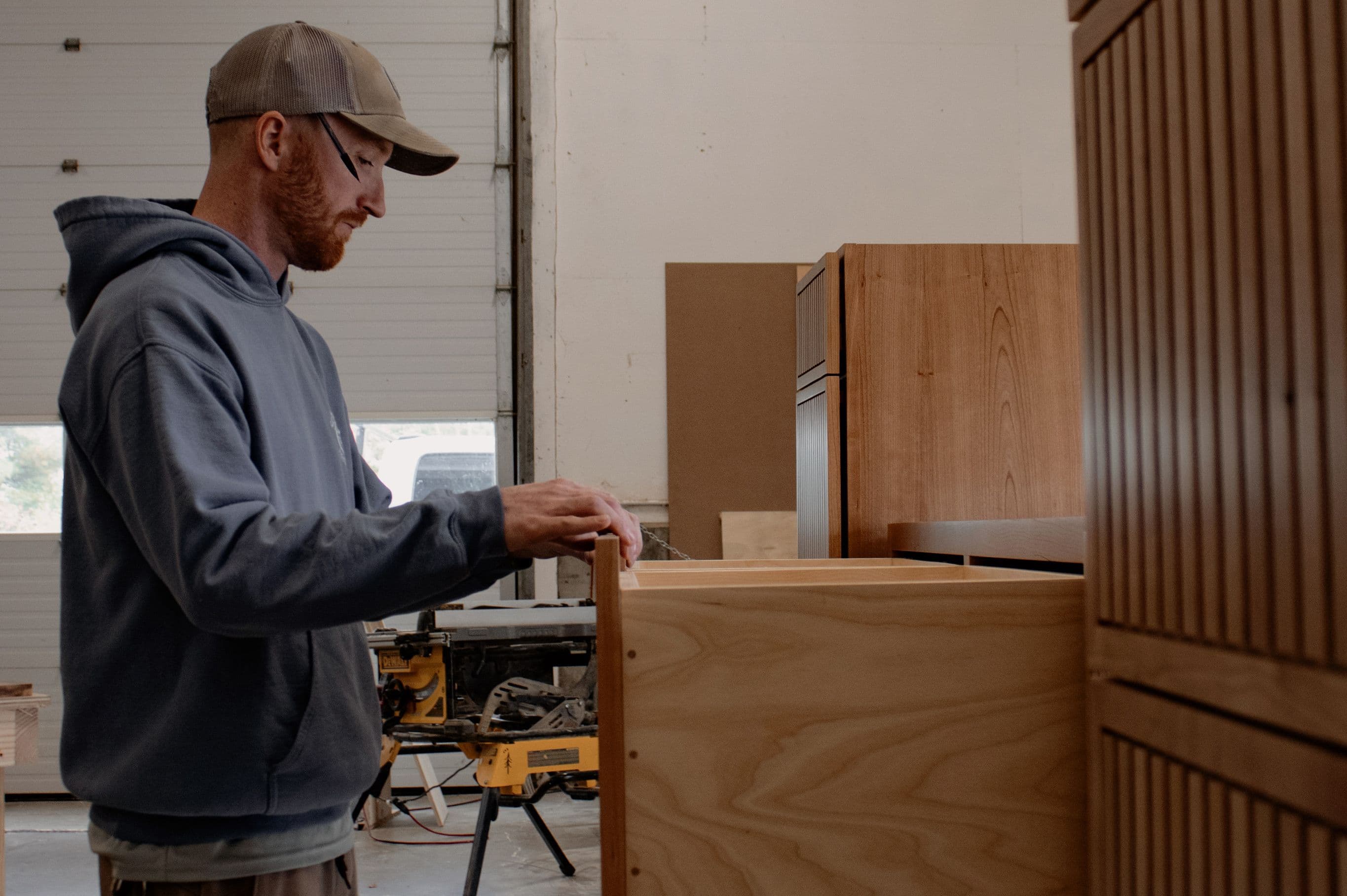 Orion Woodshop foreman Ross, examining a custom built-in before installation