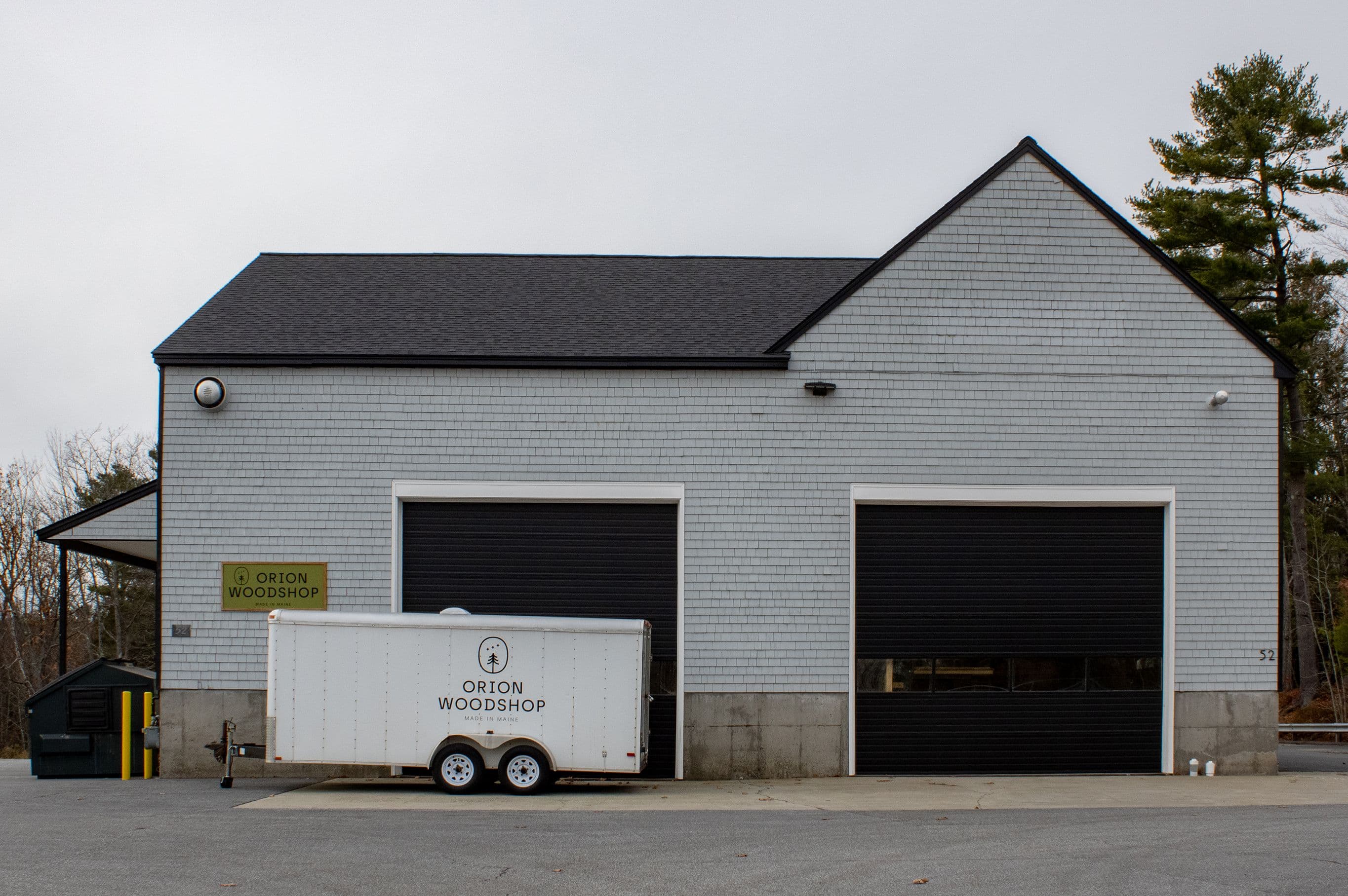 Orion Woodshop exterior with trailer and business sign out front.