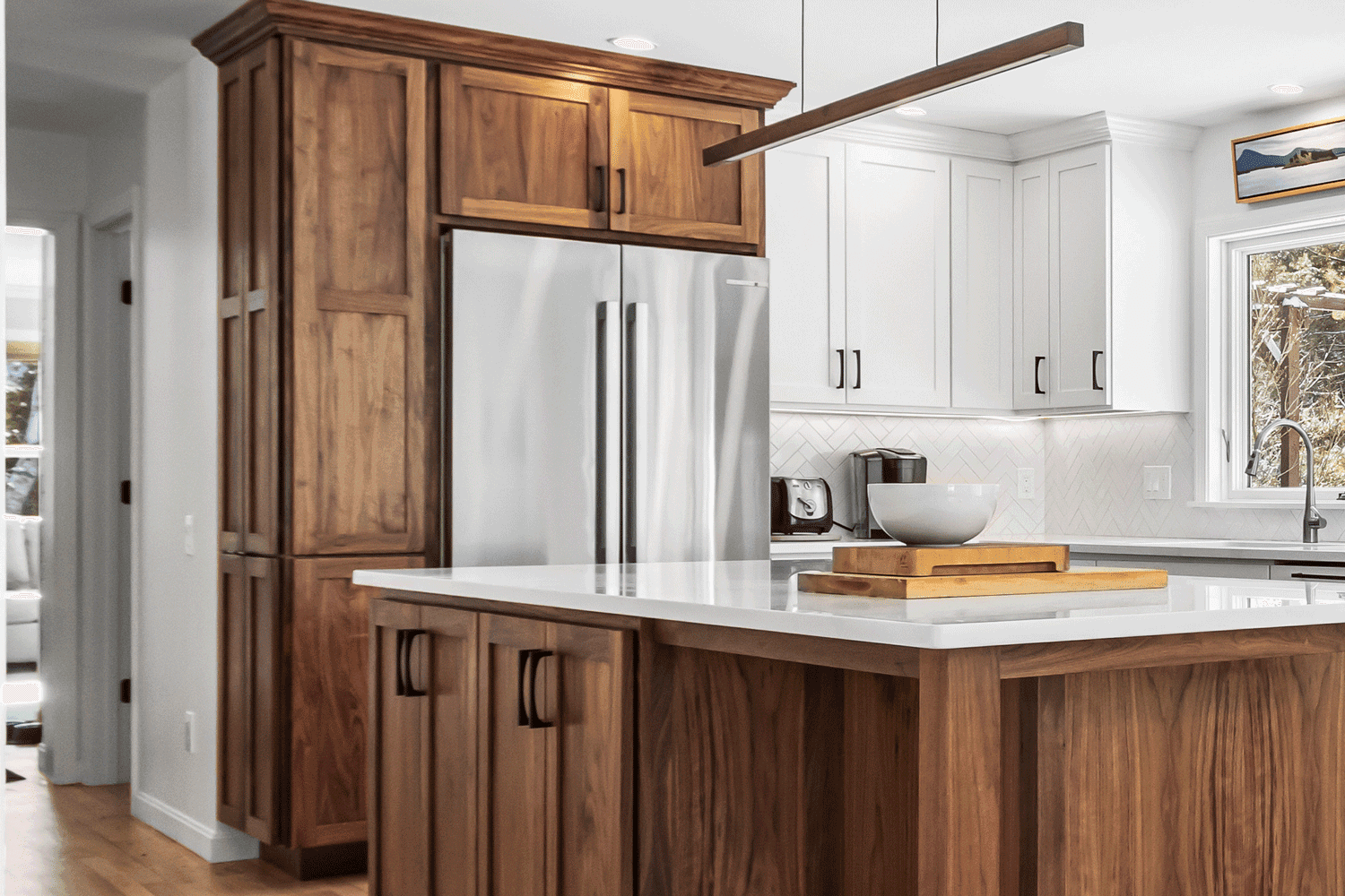 A custom pantry built-in surrounding a refrigerator, designed, built and installed by Orion Woodshop as part of a full kitchen remodel in Brunswick, Maine.