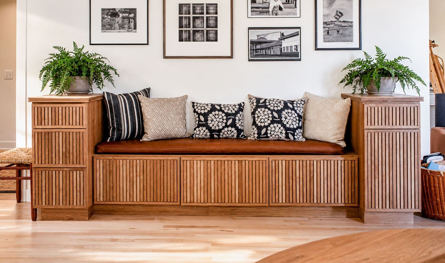 A custom built-in entryway bench by Orion Woodshop, featuring fluted drawer fronts. Custom built-in storage for a home remodel in Portland, Maine